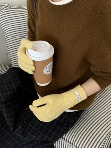 Detailed knit pattern on yellow merino wool gloves for women with touch screen feature