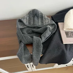 Detail of grey Fair Isle knit balaclava with warm Nordic patterns on a wooden surface