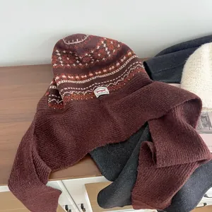 Close-up of Fair Isle pattern and thick knit texture on burgundy Balaclava hoodie