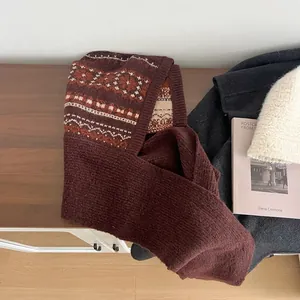 Detail of red and beige Fair Isle knit pattern on a thick warm winter balaclava hood