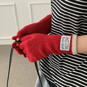Winter red knit fingerless gloves with off-white ribbed cuffs and long wrist warmers