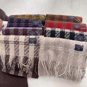 Multiple vintage plaid fringe scarves in various colors with thick warm texture
