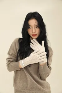 Detail of oatmeal cable knit merino wool gloves with long ribbed cuffs for women