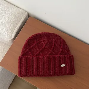 Australian wool knit beanie in burgundy with textured patterns and ear protection