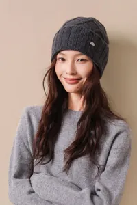 Detailed texture of dark grey Australian wool ribbed knit beanie with small metal logo
