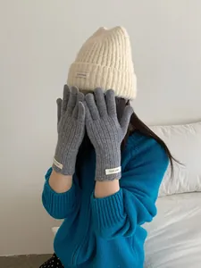 Detail of wool knit gloves and beanie showing texture and thick thermal material