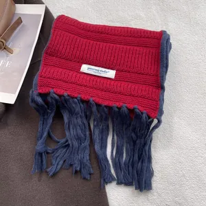 Chunky knit red and navy blue scarf with long tassels and minimalist brand label
