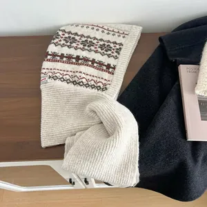 Detail of Fair Isle pattern and knitted texture on a cream Balaclava winter hat