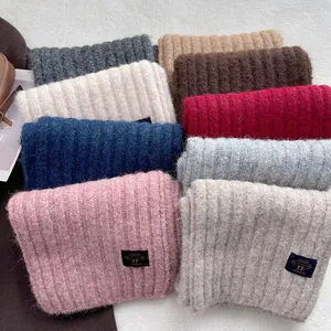 Winter rib-knit scarves in various colors with a stylish woven brand label
