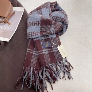 Detail of coffee and blue checkered scarf with soft texture and tassel fringe