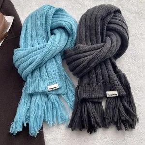 Thick ribbed knit scarf with long tassels in light blue and dark grey for winter warmth