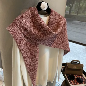 Detail shot of heavy red and white knitted wool shawl with thick texture and pattern
