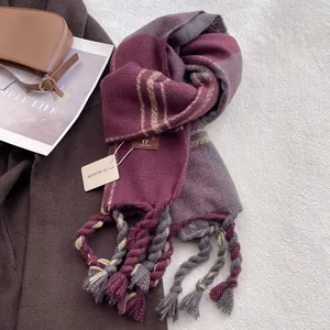 Detail of soft purple plaid scarf with thick twisted tassels and premium texture