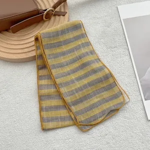 Narrow pure linen scarf with yellow and grey stripes for women on a white background