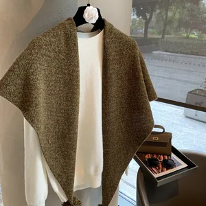 Detailed knit texture of heavy wool triangle scarf with vintage green color tones