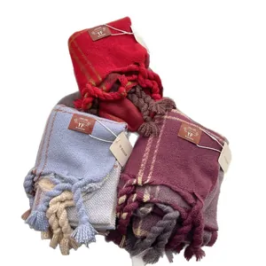 Thick checkered scarves with large tassels in red, light blue and purple colors