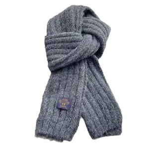 Thick dark grey ribbed knit scarf with branded tag for winter warmth and cozy style