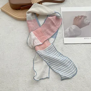 Close-up of pure linen scarf with pink and blue stripe patchwork and fine edge stitching