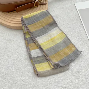 Macro view of pure linen narrow scarf with yellow and grey stripes and fine stitching
