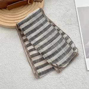 Detailed texture of pure linen striped scarf with fine contrast stitching edge