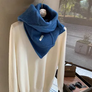 Blue wool-blend chunky knit scarf for women with elegant button detail and woven texture