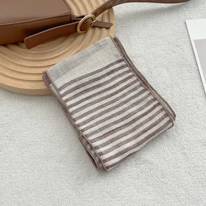 Macro detail of breathable striped linen scarf with refined texture and soft woven edges