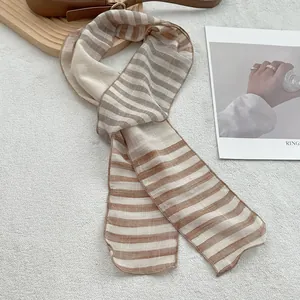 Close-up of lightweight linen neck scarf with earth tone stripes and soft textured weave
