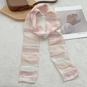 Detail of lightweight striped pure linen scarf with semi-transparent texture and fine edges