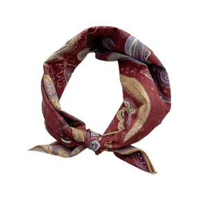 Retro burgundy paisley silk square scarf with vintage golden patterns and knotted detail