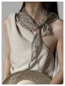 Close-up of lightweight floral pattern chiffon scarf with vintage French style details