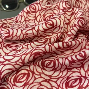 Close-up of lightweight cotton linen scarf featuring elegant red rose floral prints