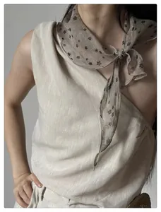 Detail of vintage floral triangle scarf paired with textured asymmetric linen top