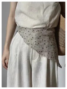French vintage floral triangular scarf styled as a waist accessory on linen trousers