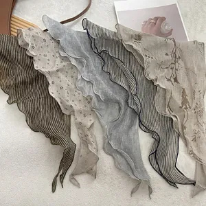 Detailed view of linen scarves featuring retro plaid patterns and elegant wavy ruffle edges