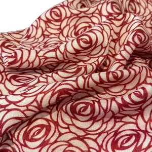 Linen cotton scarf featuring red rose floral prints on off-white fabric draped elegantly