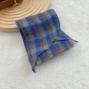 Macro detail of the 100% pure linen blue checkered scarf with dense overlock stitch edges