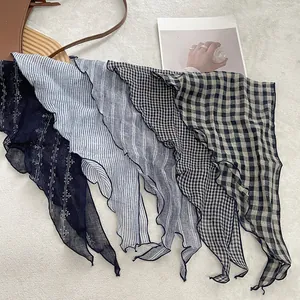 Close-up of linen neckerchiefs showing diverse patterns and delicate wavy edges