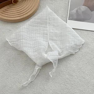 High-quality white linen triangle scarf with textured seersucker finish and ruffled edges