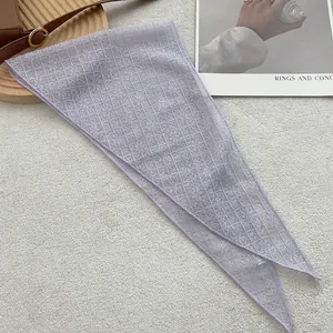Detail of light purple lace triangular scarf with intricate floral hollow patterns
