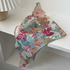 Detailed close-up of French vintage floral triangle scarf with delicate rolled hem edges