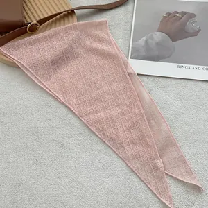 Close-up of pink lace floral scarf with mesh texture and delicate pointed edges