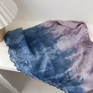 Close-up of blue and purple gradient tie-dye scarf with elegant lettuce hem detailing