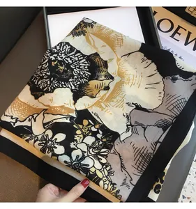 Detailed texture of cotton linen leopard print square scarf folded in a black gift box