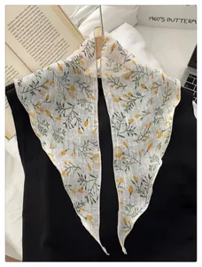 Detail of French vintage floral scarf tied on a hanger with yellow flowers and green leaves