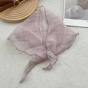 Detailed view of lavender linen kerchief with pleated texture and wavy scalloped edges