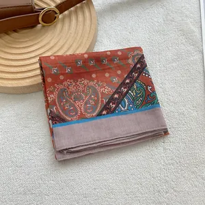Close-up of bohemian floral pattern on folded cotton linen square head scarf