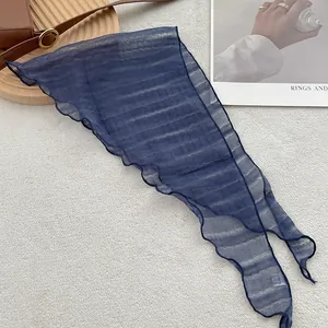 Detail of dark blue linen-texture triangle scarf showing fine wavy edges and striped fabric