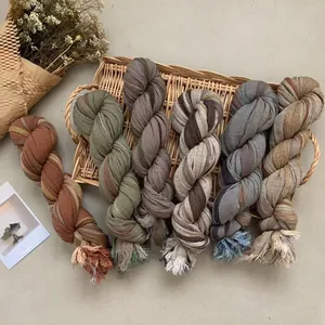 Close-up of cotton linen scarves with frayed edges in various retro earth tones