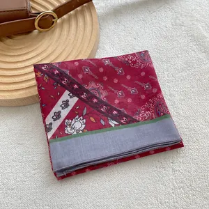 Detail of vintage red cotton linen scarf with paisley patterns and gray borders