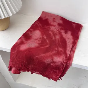 Detail of wool scarf showing artistic tie-dye gradient and natural frayed edge texture